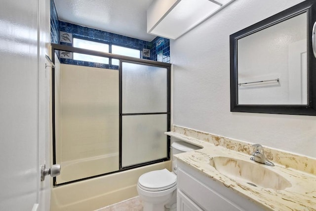 full bathroom featuring vanity, toilet, and combined bath / shower with glass door