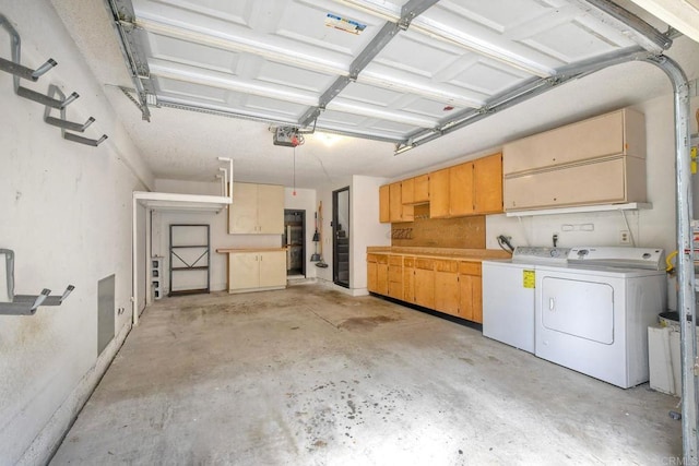 garage featuring a garage door opener and washing machine and dryer