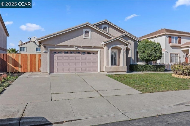 mediterranean / spanish house with a garage and a front lawn