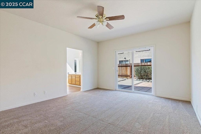 carpeted spare room with ceiling fan