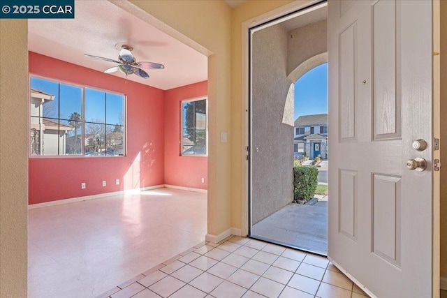 entrance foyer with light tile patterned floors, plenty of natural light, and ceiling fan