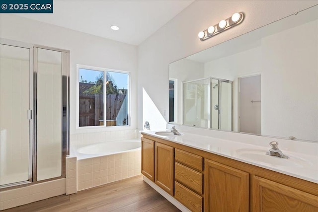 bathroom with vanity, wood-type flooring, and separate shower and tub