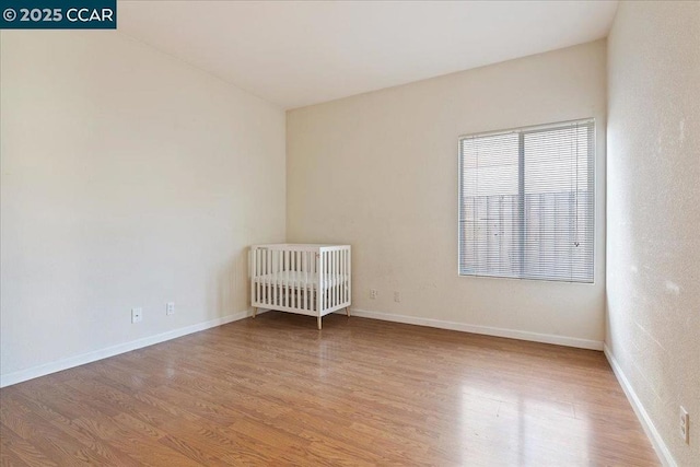 unfurnished room with light wood-type flooring