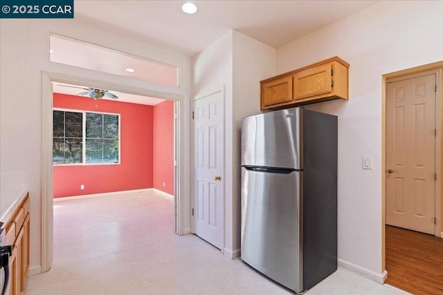 kitchen featuring ceiling fan and stainless steel refrigerator