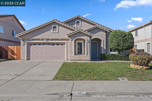 view of front of property with a garage and a front yard