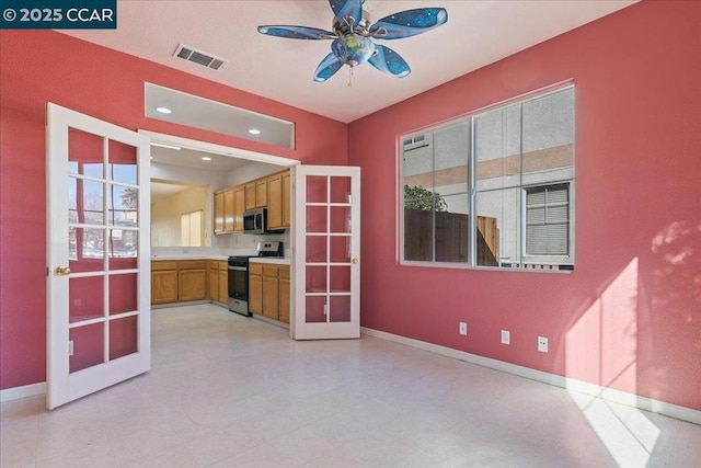 kitchen featuring stainless steel appliances, french doors, and ceiling fan