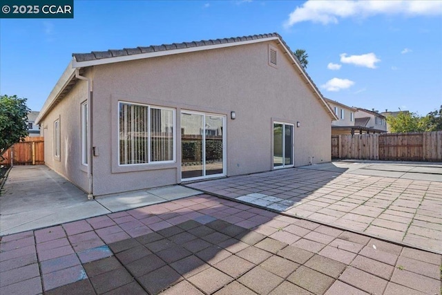 back of property with a patio