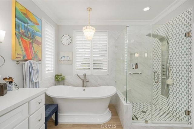 bathroom featuring hardwood / wood-style floors, plus walk in shower, vanity, and ornamental molding