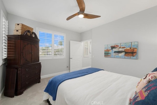 bedroom with ceiling fan and light carpet