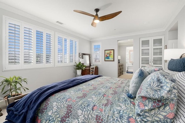 bedroom with ceiling fan, crown molding, and carpet floors