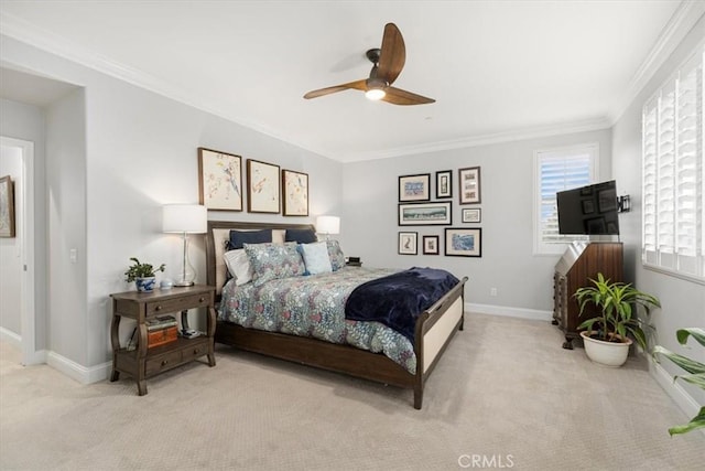 bedroom featuring ceiling fan, ornamental molding, and light colored carpet