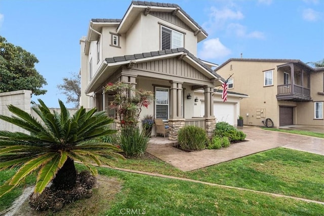 craftsman-style house featuring a front lawn and a garage