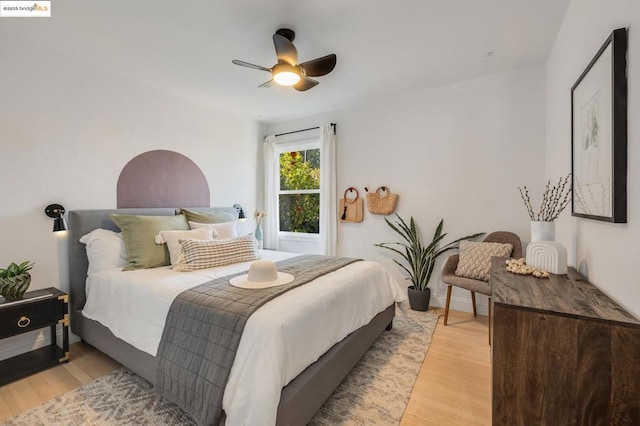 bedroom with ceiling fan and light hardwood / wood-style floors