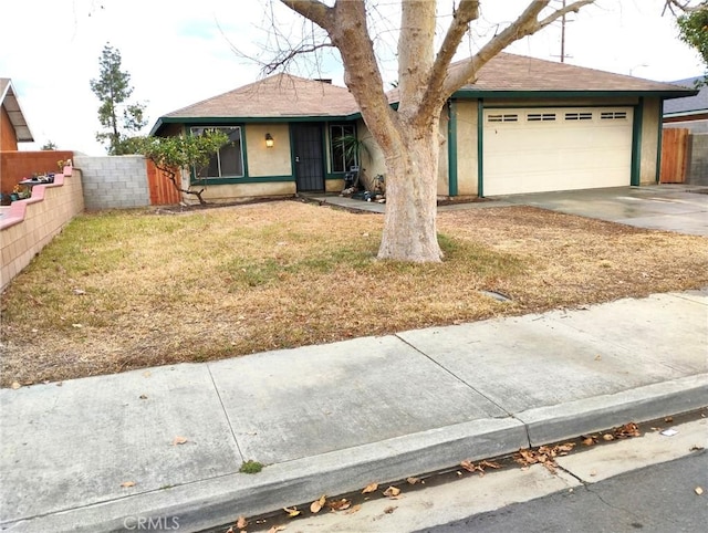 ranch-style home with a garage and a front yard