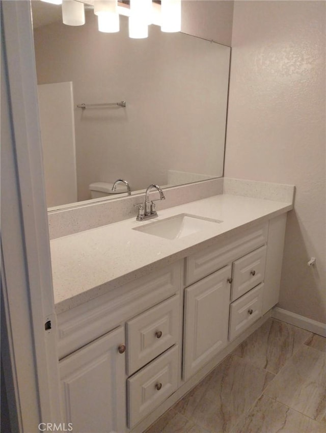 bathroom featuring vanity and toilet