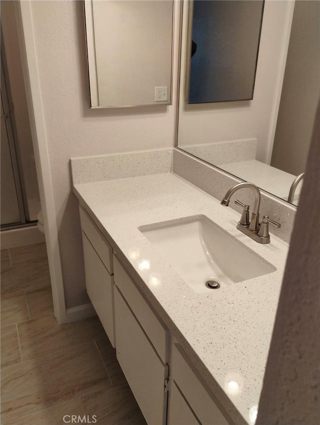 bathroom with vanity and walk in shower