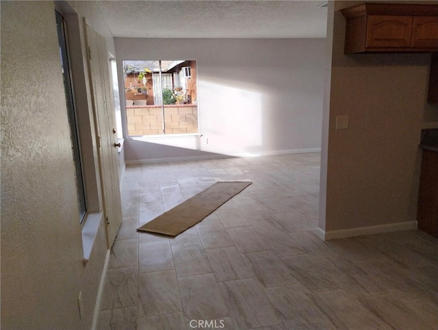 hallway with a textured ceiling