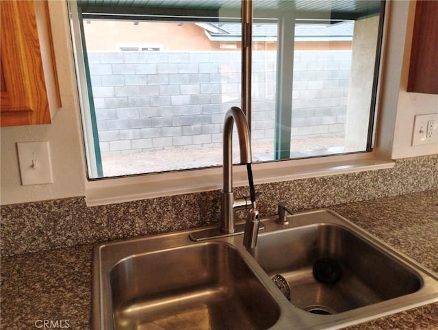 room details featuring sink and dark stone counters