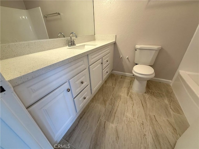 bathroom with vanity, a shower, and toilet