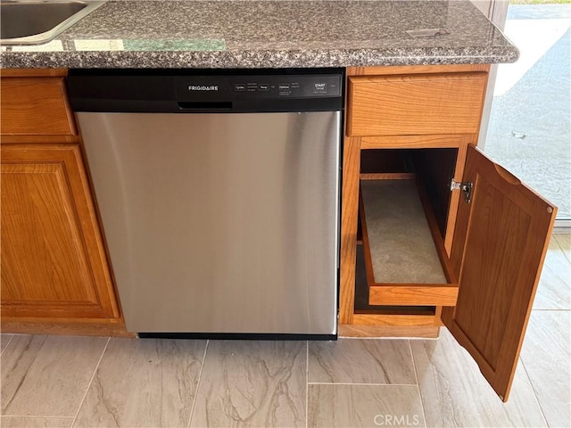 details with stainless steel dishwasher, sink, and dark stone countertops