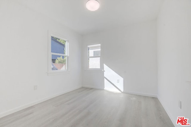 unfurnished room with light hardwood / wood-style flooring