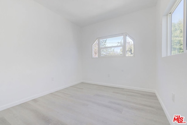 spare room featuring light hardwood / wood-style floors