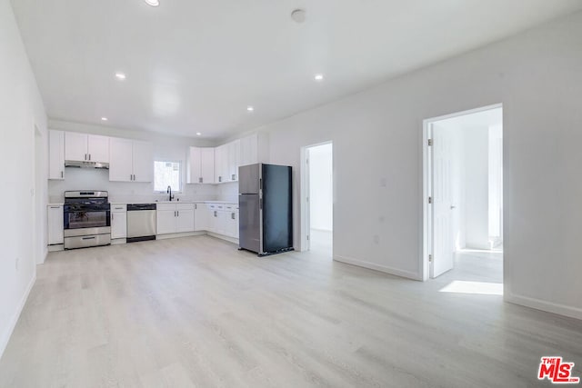 kitchen with white cabinetry, appliances with stainless steel finishes, sink, and light hardwood / wood-style floors