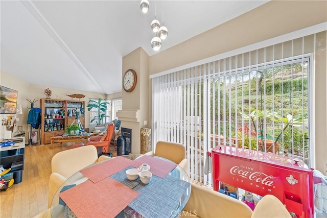 dining area featuring vaulted ceiling and hardwood / wood-style floors