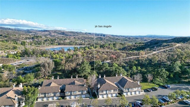 drone / aerial view featuring a water and mountain view