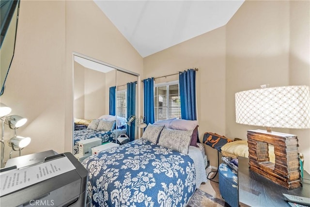 bedroom featuring vaulted ceiling and a closet