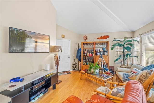 living room with lofted ceiling and hardwood / wood-style floors