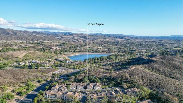 drone / aerial view with a water and mountain view