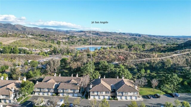 birds eye view of property featuring a water and mountain view