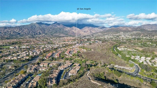 birds eye view of property featuring a mountain view