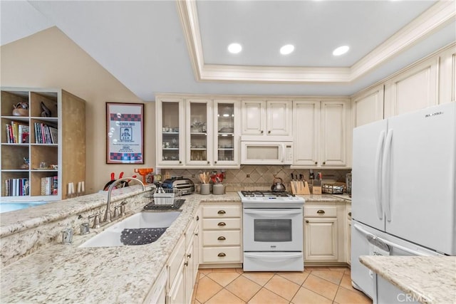 kitchen with light stone counters, sink, white appliances, and light tile patterned flooring