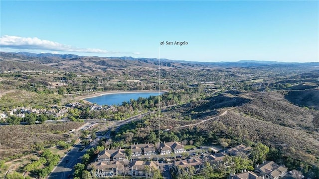 birds eye view of property with a water and mountain view