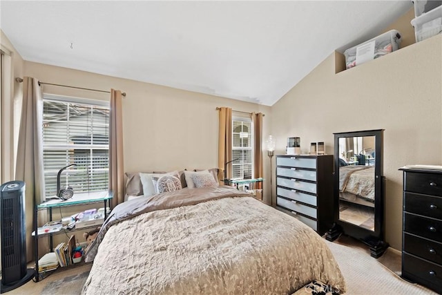 bedroom featuring multiple windows and vaulted ceiling