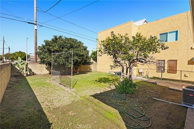 view of yard featuring a fenced backyard and central AC