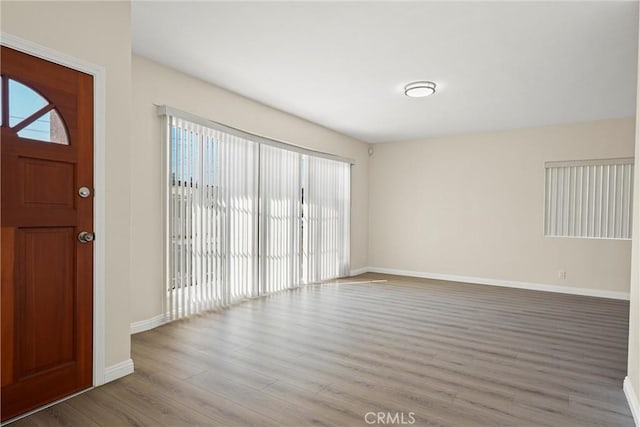 foyer entrance with light wood-type flooring and baseboards