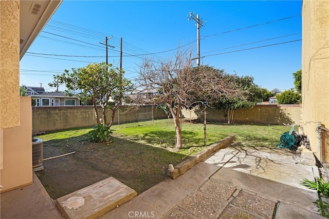 view of yard with a patio area, a fenced backyard, and cooling unit