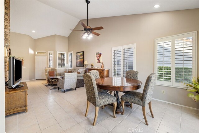 dining room featuring light tile patterned flooring, ceiling fan, and high vaulted ceiling