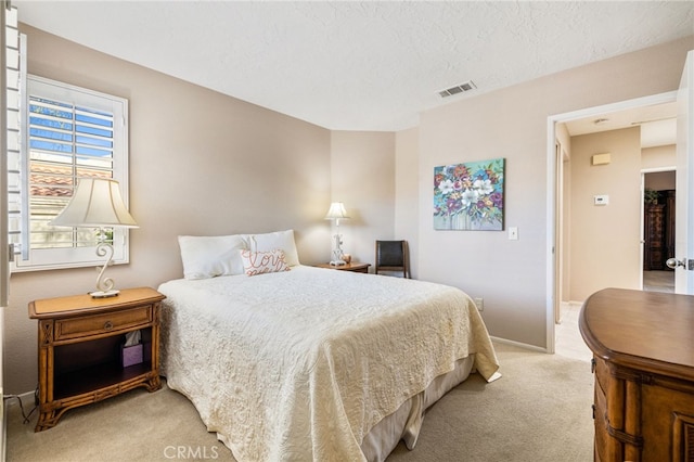 carpeted bedroom featuring a textured ceiling