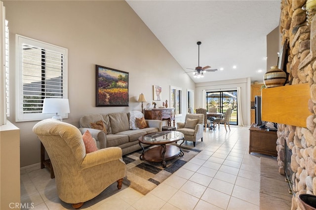 living room featuring ceiling fan, light tile patterned floors, and high vaulted ceiling