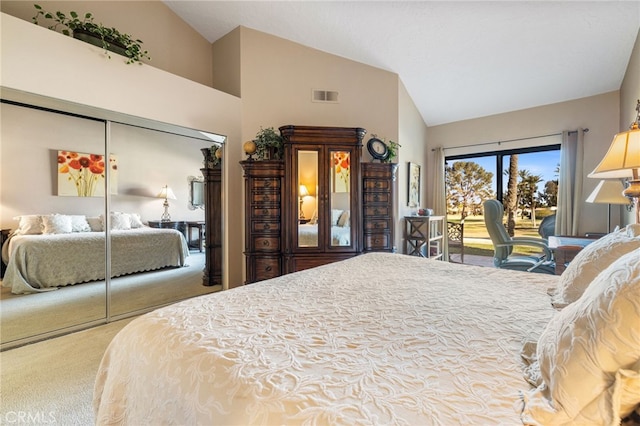 bedroom featuring vaulted ceiling, carpet floors, a closet, and access to outside