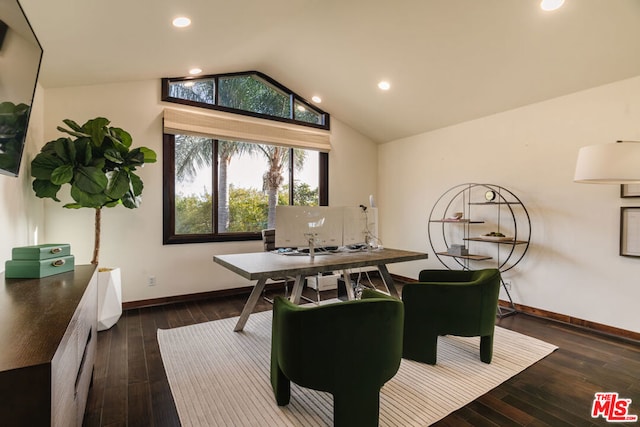 dining room with dark wood-type flooring and vaulted ceiling