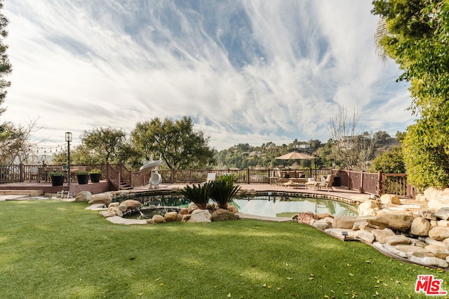 view of yard featuring a fenced in pool