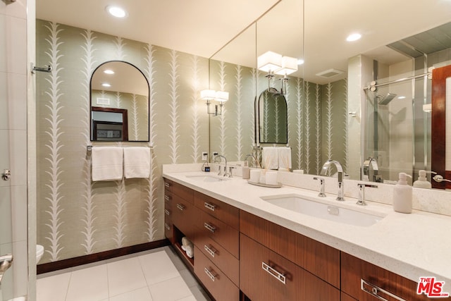 bathroom with walk in shower, vanity, toilet, and tile patterned flooring