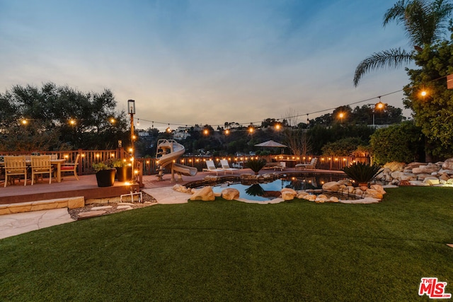 yard at dusk with a playground