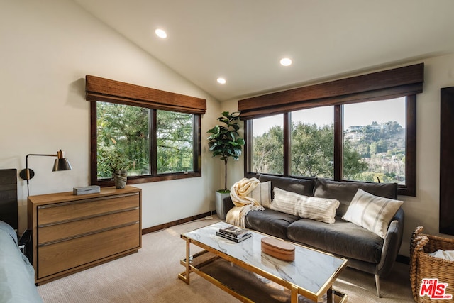 living room featuring vaulted ceiling and light colored carpet