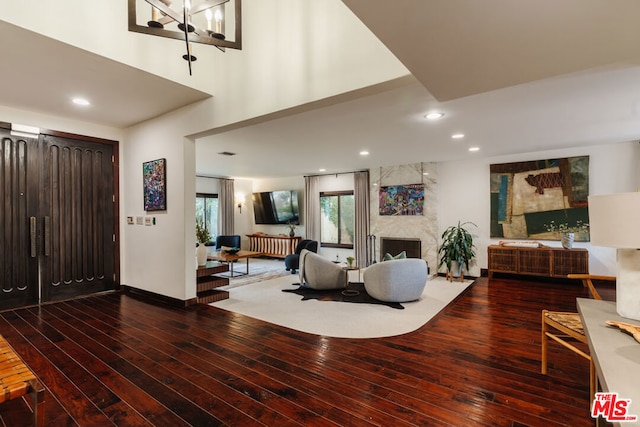 living room featuring a large fireplace and hardwood / wood-style floors